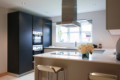 This is an example of a contemporary u-shaped kitchen/diner in Hampshire with no island.