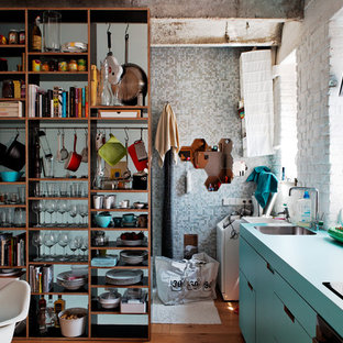 This is an example of an industrial single-wall open plan kitchen with open cabinets, blue cabinets and turquoise benchtop.