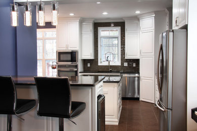 Example of a large trendy u-shaped ceramic tile open concept kitchen design in Ottawa with a single-bowl sink, beaded inset cabinets, white cabinets, granite countertops, brown backsplash, glass tile backsplash, stainless steel appliances and an island