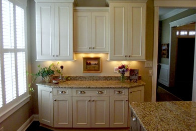Example of a classic kitchen design in Indianapolis with recessed-panel cabinets, white cabinets and granite countertops
