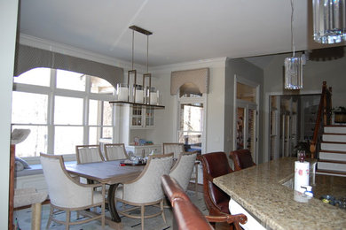 Example of a mid-sized trendy u-shaped carpeted eat-in kitchen design in Atlanta with a drop-in sink, raised-panel cabinets, white cabinets, marble countertops, white backsplash, subway tile backsplash, stainless steel appliances and no island