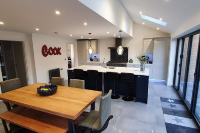 Large contemporary single-wall kitchen/diner in Buckinghamshire with shaker cabinets and an island.