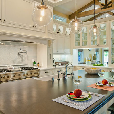 Inspiration for a timeless eat-in kitchen remodel in Los Angeles with a farmhouse sink, glass-front cabinets, white cabinets, white backsplash and subway tile backsplash