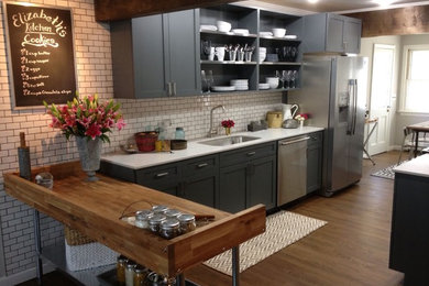 Example of a trendy galley eat-in kitchen design in New York with an undermount sink, shaker cabinets, gray cabinets, quartzite countertops, white backsplash, subway tile backsplash and stainless steel appliances