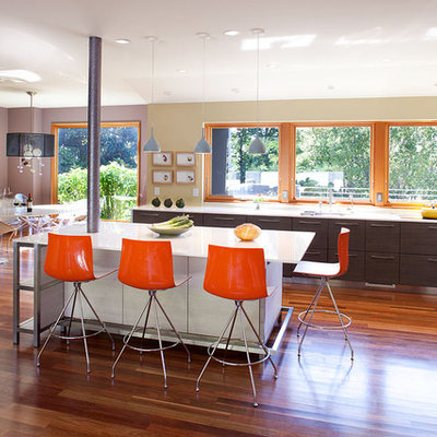 Large trendy galley medium tone wood floor and brown floor open concept kitchen photo in San Francisco with quartz countertops, an undermount sink, flat-panel cabinets, stainless steel appliances and an island