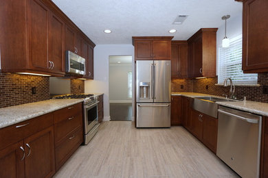 Example of a large trendy galley porcelain tile and multicolored floor eat-in kitchen design in Houston with an undermount sink, recessed-panel cabinets, medium tone wood cabinets, granite countertops, multicolored backsplash, mosaic tile backsplash, stainless steel appliances, an island and multicolored countertops