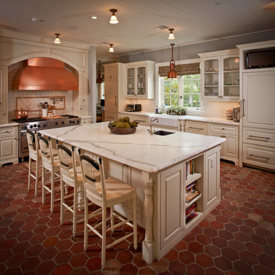 Inspiration for a timeless kitchen remodel in Houston with a farmhouse sink, glass-front cabinets, beige cabinets, white backsplash, subway tile backsplash and paneled appliances