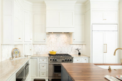 Elegant l-shaped dark wood floor and brown floor kitchen photo in Kansas City with an undermount sink, beaded inset cabinets, white cabinets, white backsplash, stainless steel appliances, an island and beige countertops