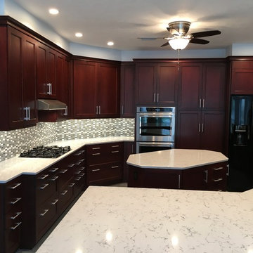 Bright kitchen with dark cabinets and white countertops & island