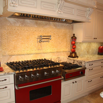 Bright red Viking range topped by a massive carved custom hood
