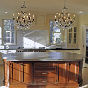 Mid-sized victorian eat-in kitchen in Other with a farmhouse sink, white cabinets, white splashback, stainless steel appliances, with island, shaker cabinets, zinc benchtops, subway tile splashback, ceramic floors and beige floor.