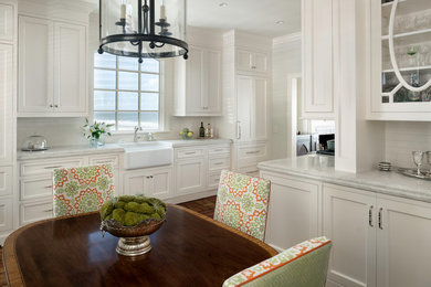 Eat-in kitchen - mid-sized transitional eat-in kitchen idea in Jacksonville with a farmhouse sink, beaded inset cabinets, white cabinets and no island