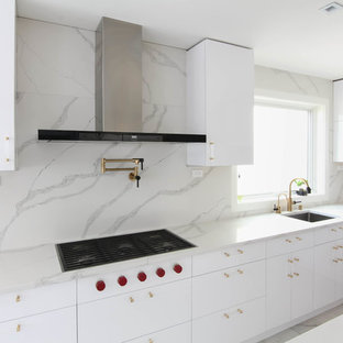 Design ideas for a large contemporary eat-in kitchen in New York with an undermount sink, flat-panel cabinets, white cabinets, quartzite benchtops, multi-coloured splashback, stone slab splashback, stainless steel appliances, ceramic floors, with island, yellow floor and white benchtop.