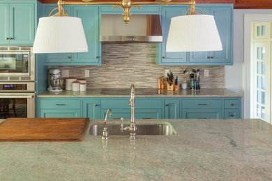 Design ideas for a large classic single-wall kitchen/diner in Portland Maine with a single-bowl sink, shaker cabinets, blue cabinets, granite worktops, brown splashback, glass tiled splashback, stainless steel appliances, an island and turquoise worktops.
