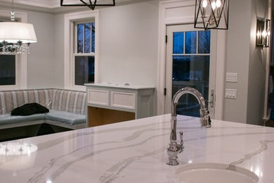 Example of an eat-in kitchen design in Providence with quartz countertops and an island
