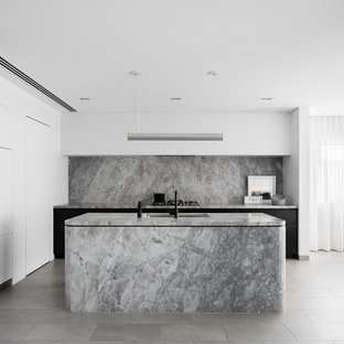 Photo of a modern l-shaped kitchen in Sydney with an undermount sink, flat-panel cabinets, black cabinets, grey splashback, marble splashback, panelled appliances, with island, grey floor and grey benchtop.