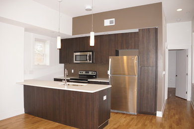 Example of a small minimalist galley eat-in kitchen design in Cincinnati with flat-panel cabinets, gray cabinets, quartzite countertops, ceramic backsplash, stainless steel appliances and a peninsula