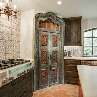 Design ideas for a large mediterranean u-shaped eat-in kitchen in Dallas with an undermount sink, shaker cabinets, distressed cabinets, quartz benchtops, multi-coloured splashback, porcelain splashback, stainless steel appliances, terra-cotta floors and with island.