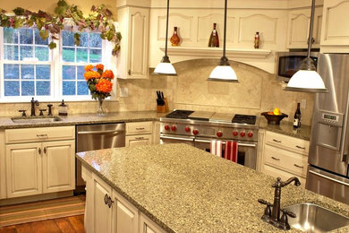 Inspiration for a medium sized classic u-shaped enclosed kitchen in Orange County with a submerged sink, raised-panel cabinets, white cabinets, granite worktops, beige splashback, ceramic splashback, stainless steel appliances, medium hardwood flooring, an island and brown floors.