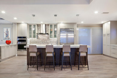 Open concept kitchen - large contemporary galley porcelain tile and multicolored floor open concept kitchen idea in Miami with an undermount sink, shaker cabinets, beige cabinets, quartzite countertops, multicolored backsplash, glass tile backsplash, stainless steel appliances and an island