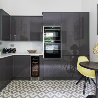 This is an example of a small contemporary l-shaped kitchen/diner in London with flat-panel cabinets, grey cabinets, ceramic flooring, no island and white floors.