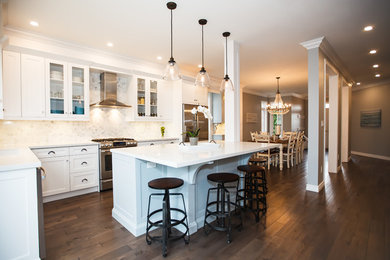 Mid-sized transitional galley dark wood floor eat-in kitchen photo in Toronto with an undermount sink, shaker cabinets, white cabinets, granite countertops, white backsplash, stone tile backsplash, stainless steel appliances and an island