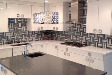 Inspiration for a large modern u-shaped porcelain tile and white floor kitchen pantry remodel in New York with an undermount sink, flat-panel cabinets, white cabinets, quartz countertops, multicolored backsplash, mosaic tile backsplash, stainless steel appliances and an island