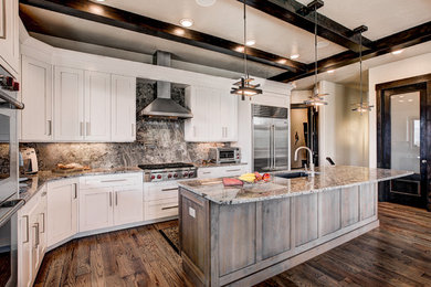 Inspiration for a huge modern l-shaped medium tone wood floor open concept kitchen remodel in Denver with a drop-in sink, shaker cabinets, white cabinets, quartz countertops, multicolored backsplash, stainless steel appliances and an island