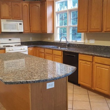 Brownie granite as the finishing touch to this warm country kitchen.