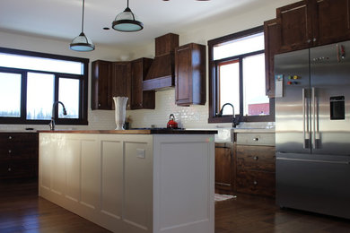 Example of a classic kitchen design in Vancouver with flat-panel cabinets and brown cabinets