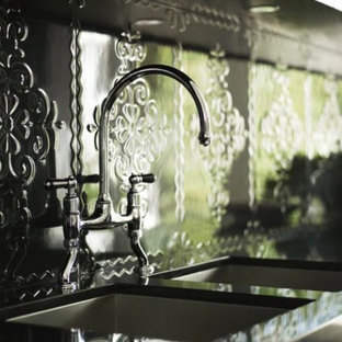 Inspiration for a large contemporary single-wall open plan kitchen in Other with a double-bowl sink, flat-panel cabinets, stainless steel cabinets, quartzite benchtops, metallic splashback, metal splashback, stainless steel appliances, marble floors, with island and grey floor.