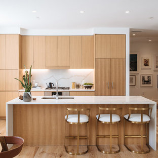 Contemporary open concept kitchen ideas - Trendy galley medium tone wood floor and brown floor open concept kitchen photo in DC Metro with an integrated sink, flat-panel cabinets, medium tone wood cabinets, marble countertops, white backsplash, marble backsplash and an island