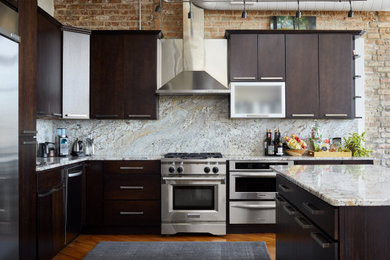 Inspiration for a large industrial l-shaped medium tone wood floor eat-in kitchen remodel in Chicago with a drop-in sink, flat-panel cabinets, dark wood cabinets, marble countertops, multicolored backsplash, marble backsplash, stainless steel appliances and an island