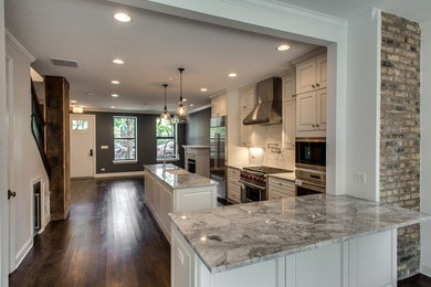 Mid-sized transitional galley dark wood floor and brown floor enclosed kitchen photo in Chicago with a farmhouse sink, raised-panel cabinets, white cabinets, marble countertops, white backsplash, mosaic tile backsplash, stainless steel appliances and an island
