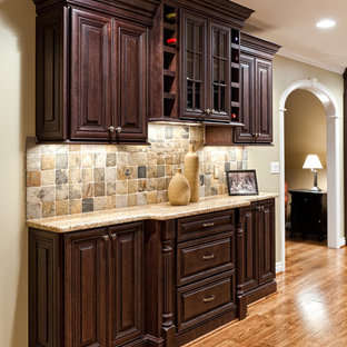 Large traditional eat-in kitchen ideas - Eat-in kitchen - large traditional u-shaped medium tone wood floor and brown floor eat-in kitchen idea in Detroit with an undermount sink, raised-panel cabinets, dark wood cabinets, granite countertops, multicolored backsplash, stone tile backsplash, stainless steel appliances and an island