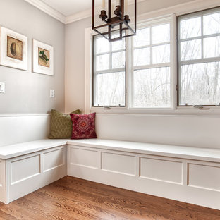 Mid-sized transitional eat-in kitchen photos - Example of a mid-sized transitional galley medium tone wood floor and brown floor eat-in kitchen design in New York with an undermount sink, beaded inset cabinets, white cabinets, quartzite countertops, white backsplash, mosaic tile backsplash, stainless steel appliances, an island and white countertops