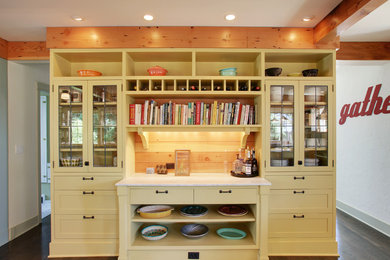 Example of a classic kitchen design in Seattle with glass-front cabinets and yellow cabinets