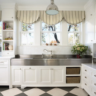 Inspiration for a large timeless u-shaped multicolored floor enclosed kitchen remodel in Minneapolis with recessed-panel cabinets, white cabinets, white backsplash, stainless steel appliances, a farmhouse sink, marble countertops, stone tile backsplash and an island