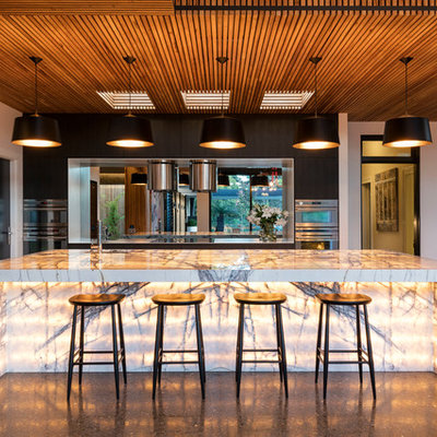 Example of a large trendy l-shaped kitchen design in Wollongong with an undermount sink, mirror backsplash, stainless steel appliances and an island