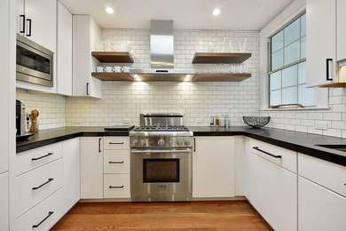 Kitchen - small modern u-shaped medium tone wood floor and brown floor kitchen idea in San Francisco with an undermount sink, beaded inset cabinets, white cabinets, soapstone countertops, white backsplash, ceramic backsplash, stainless steel appliances and a peninsula