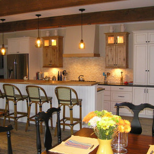 Mid-sized eat-in kitchen designs - Eat-in kitchen - mid-sized single-wall linoleum floor and gray floor eat-in kitchen idea in Other with a drop-in sink, recessed-panel cabinets, white cabinets, wood countertops, beige backsplash, brick backsplash, stainless steel appliances and an island