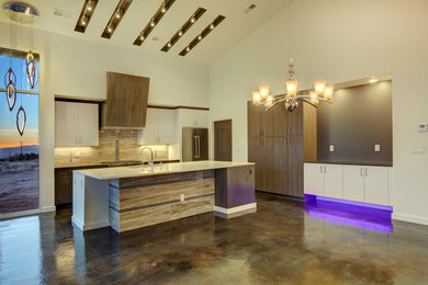 Inspiration for a large contemporary l-shaped concrete floor open concept kitchen remodel in Albuquerque with an undermount sink, flat-panel cabinets, medium tone wood cabinets, quartz countertops, beige backsplash, stone slab backsplash, stainless steel appliances and an island