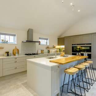 Design ideas for a country kitchen in Other with a submerged sink, shaker cabinets, grey cabinets, grey splashback, an island, grey floors and grey worktops.