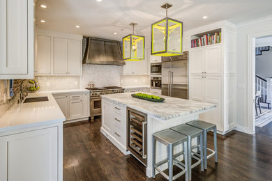 Inspiration for a transitional u-shaped dark wood floor kitchen remodel in San Francisco with shaker cabinets, white cabinets, white backsplash, subway tile backsplash, stainless steel appliances and an island