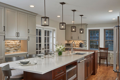Mid-sized transitional l-shaped dark wood floor and brown floor kitchen pantry photo in Boston with an undermount sink, recessed-panel cabinets, gray cabinets, quartz countertops, multicolored backsplash, glass tile backsplash, stainless steel appliances and an island