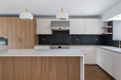 Eat-in kitchen - large contemporary eat-in kitchen idea in Vancouver with flat-panel cabinets, porcelain backsplash, stainless steel appliances and an island