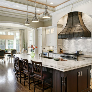 Traditional eat-in kitchen pictures - Eat-in kitchen - traditional eat-in kitchen idea in Chicago with a double-bowl sink, recessed-panel cabinets, white cabinets, white backsplash, stone tile backsplash and stainless steel appliances