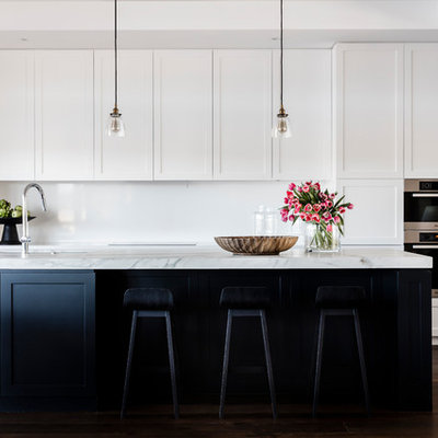 Inspiration for a transitional galley dark wood floor kitchen remodel in Sydney with an undermount sink, shaker cabinets, white backsplash and an island