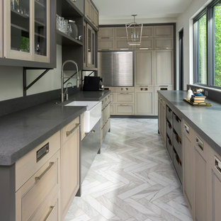 Photo of a large contemporary galley separate kitchen in Salt Lake City with a farmhouse sink, recessed-panel cabinets, stainless steel appliances, marble floors, no island, brown cabinets, concrete benchtops and grey floor.