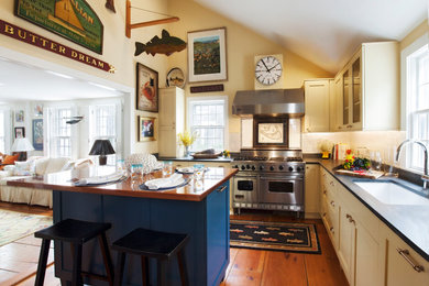 Inspiration for a mid-sized timeless medium tone wood floor kitchen remodel in Boston with a single-bowl sink, shaker cabinets, blue cabinets, wood countertops, stainless steel appliances and an island